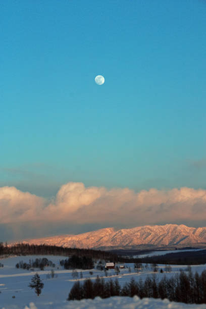 istock Moon and blue sky above the snowy mountains 1285035204