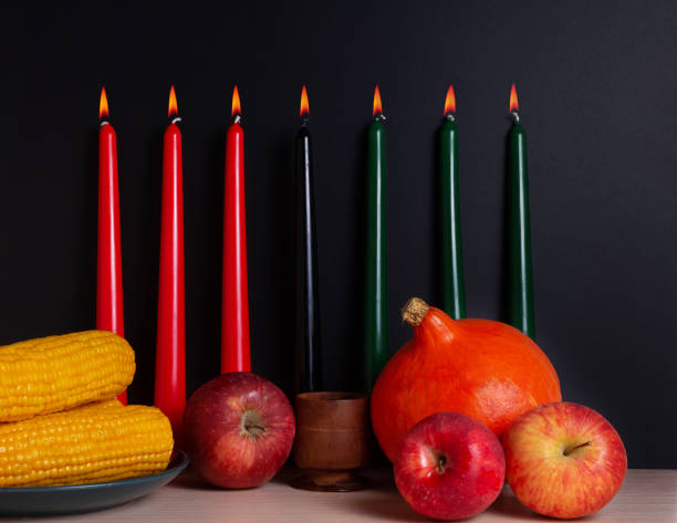 Kwanzaa Afro-American holiday. Corn, bowl and harvest. Kwanzaa banner with candles on light background and copy space on the right. Afro-American holiday. Seven candles as symbol of principles of African Heritage. angolan kwanza photos stock pictures, royalty-free photos & images