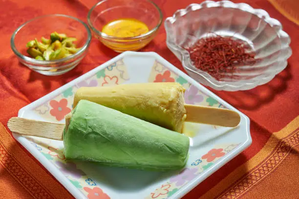 14 Oct 2015 FOOD Kesar Pista Kulfi on plate and ingredients studio shot Kalyan Maharashtra India