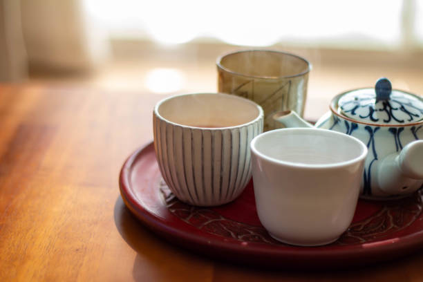 istock A hot water drink with a kyusu placed on a sunny table and freshly brewed roasted green tea 1285037110