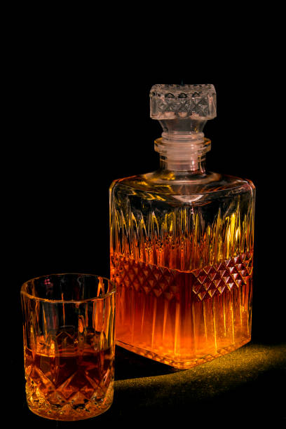 istock Carafe and glasses with ice drink on a black background 1285037226