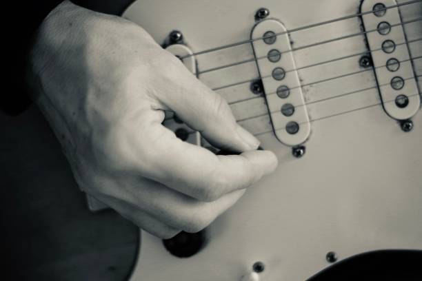 istock Close up of hands playing guitar 1285038230