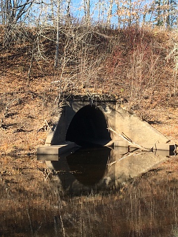 Large water culvert in New Brunswick woodlands.