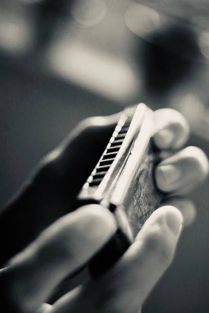Close up of hands holding a harmonica. The harmonica, also known as a French harp or mouth organ, is a free reed wind instrument used worldwide in many musical genres, notably in blues, American folk music, classical music, jazz, country, and rock. The many types of harmonica include diatonic, chromatic, tremolo, octave, orchestral, and bass versions.