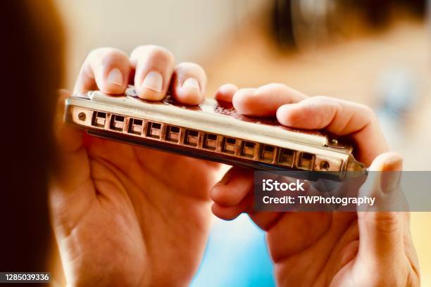 Close Up Of Hands Holding A Harmonica Stock Photo - Download Image Now - Harmonica, Harmony, Music Festival