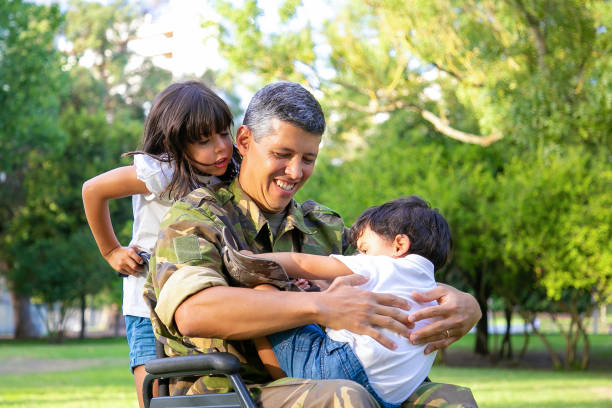 istock Happy disabled military dad walking with two children 1285040187