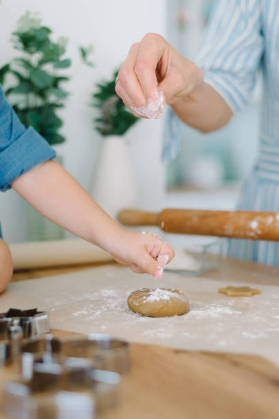 istock Mother and daughter preparing christmas cookies, tree shape 1285040959