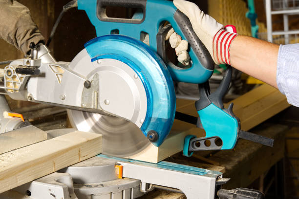 istock Carpenter work with circular saw for cutting wood bar, the man sawed bars, construction and home renovation. Carpenter work concept 1285043624
