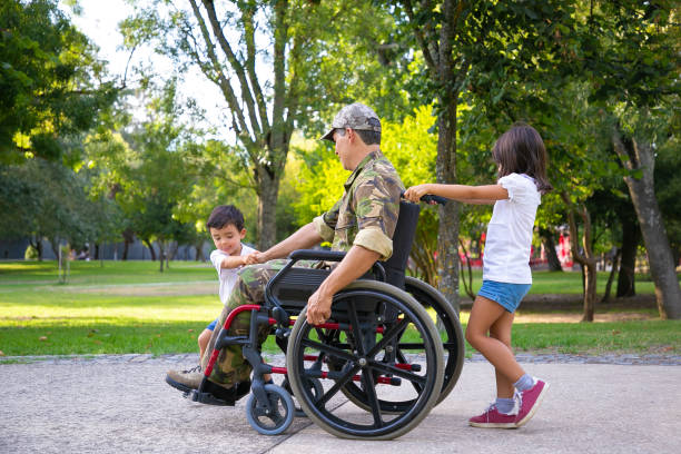 istock Two little kids walking with military disabled dad 1285044072