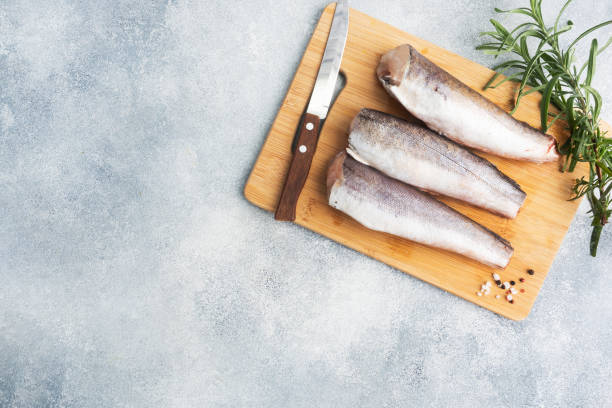 istock Raw hake fish carcass on a wooden chopping Board. top view Copy space 1285044952