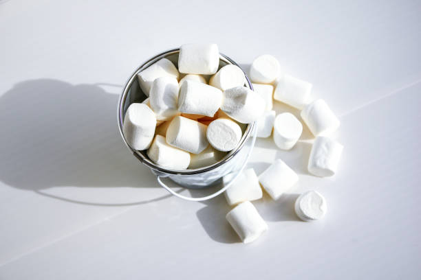 istock White mini marshmallows background close-up texture. Food background. Copy space. White metal bucket 1285045249