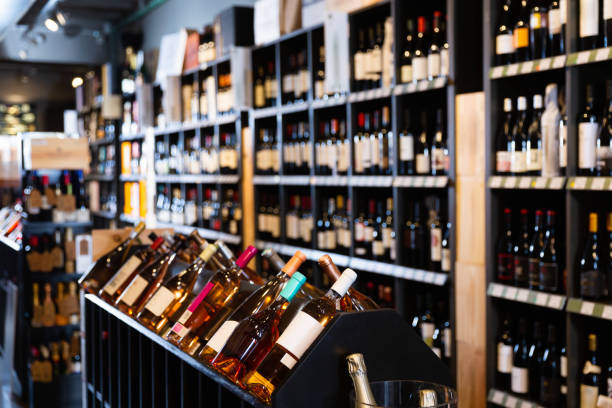 istock Rack with various wine bottles in modern wine store waiting for customers 1285046518