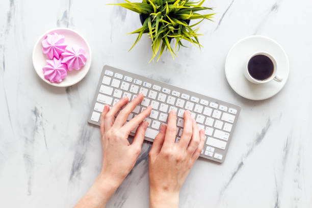 istock Notebook with  lavender flower branches and keyboard on grey stone background top view. 1285047384