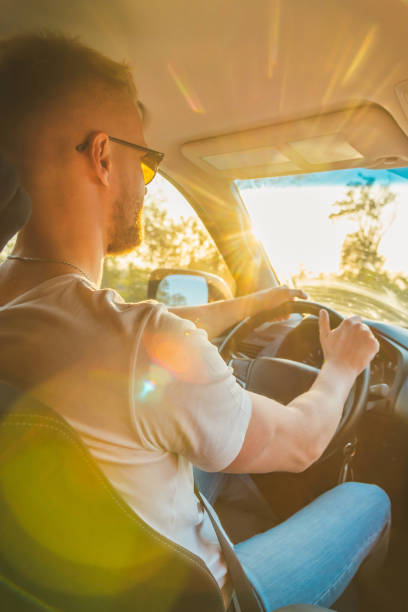 a man driving a car on a sunny day - window sun sunlight vertical imagens e fotografias de stock