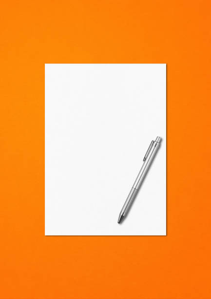 A shiny orange fountain pen together with a spiral-bound ruled notebook.