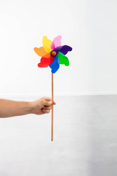 istock Hand Holding Colorful Plastic Toy Windmill 1285052301
