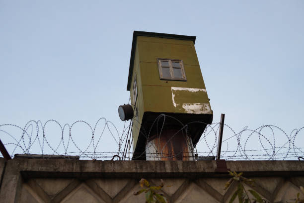 istock prison watchtower behind barbed wire in the zone 1285052383