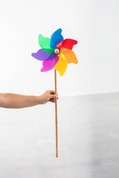 istock Hand Holding Colorful Plastic Toy Windmill 1285053001