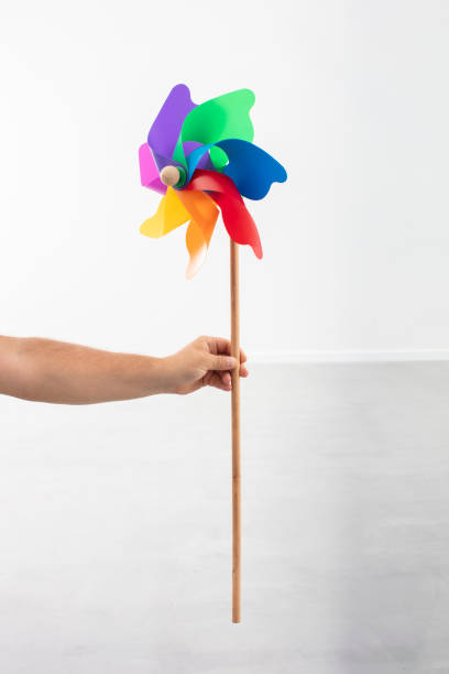istock Hand Holding Colorful Plastic Toy Windmill 1285053174