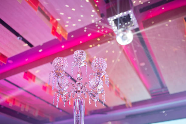 istock Low angle view crystal glass candlesticks and disco Ball as background 1285054675
