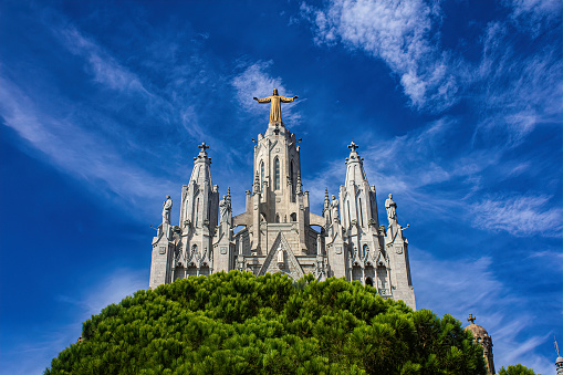 Barcelona, Catalonia, Spain - October 01, 2019: The majestic sumptuous facade of the Gothic Church of the Sacred Heart on Mount Tibidabo in Barcelona, Catalonia. Famous elaborately decorated Barcelona architecture, popular tourist attraction