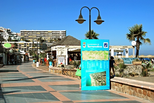 View along the promenade with beach bars on the right hand side, Torremolinos, Spain.