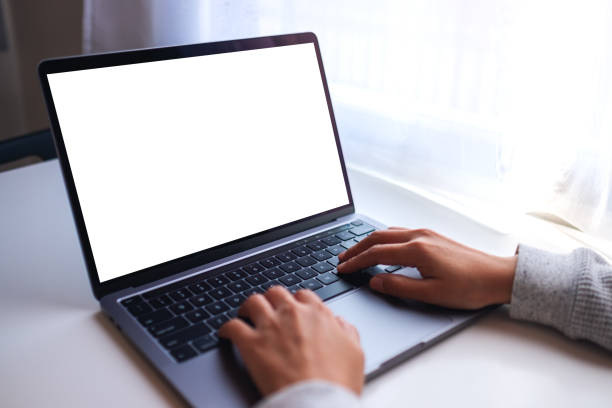 istock a businesswoman using and typing on laptop computer keyboard with blank white desktop screen on the table 1285057955