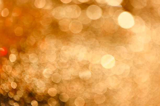 istock Defocused glittering black background of warm bokeh lights 1285058566