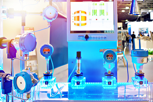 Electronic digital pressure gauge and water flow calculation equipment at an industrial exhibition