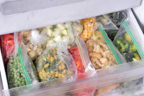 istock Plastic bags with deep frozen vegetables in refrigerator, closeup 1285060902