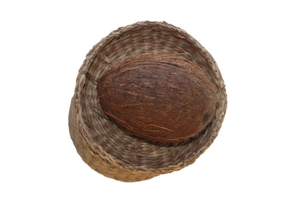 One Coconut In A Wicker Plate In Selective Focus. Isolated Image On A White Background With Copy Space.