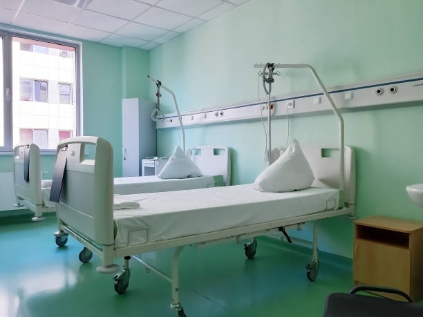 istock Two hospital beds on wheels in a hospital bed on windows backgraund 1285061198