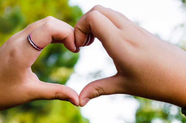 istock Young girl with heart-shaped hands 1285062005