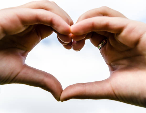istock Young girl with heart-shaped hands 1285062007