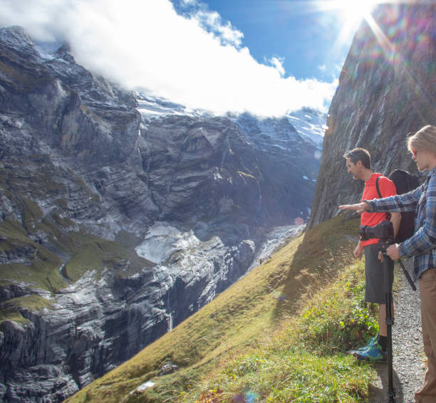 istock Hikers relax on sunny mountain ridge 1285062214