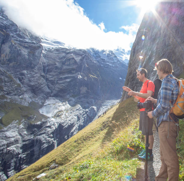 istock Hikers relax on sunny mountain ridge 1285063444