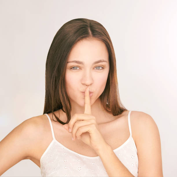 istock Young beauty girl. Shh concept. Silent gesture 1285064690