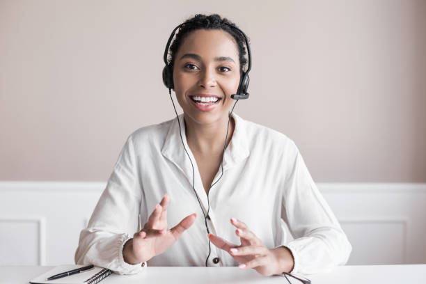 Laptop web cam view of mixed race woman. Girl wearing headset have video conference call using phone or computer. Distance chat conversation between friends, job interview remotely, dating concept headset stock pictures, royalty-free photos & images