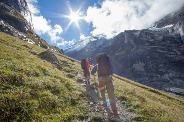 istock Friends hike up sunny mountain ridge 1285065744