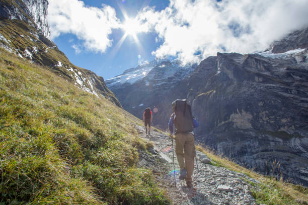 istock Friends hike up sunny mountain ridge 1285065857