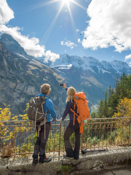 istock Hiking couple relaxes on sunny mountain ridge 1285066377