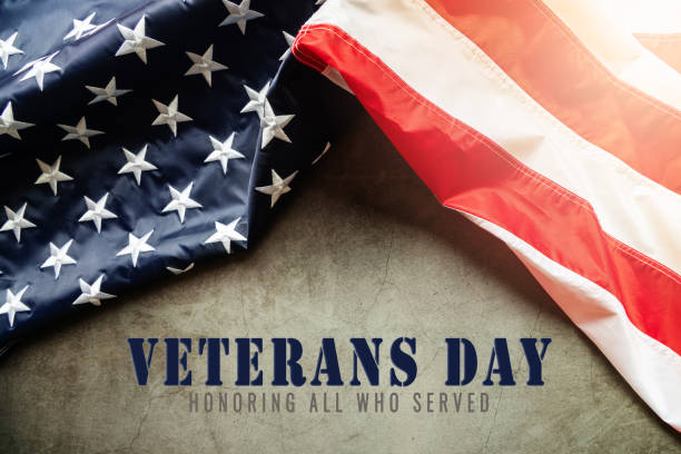 istock Veterans day. Honoring all who served. American flag on cement background 1285067487