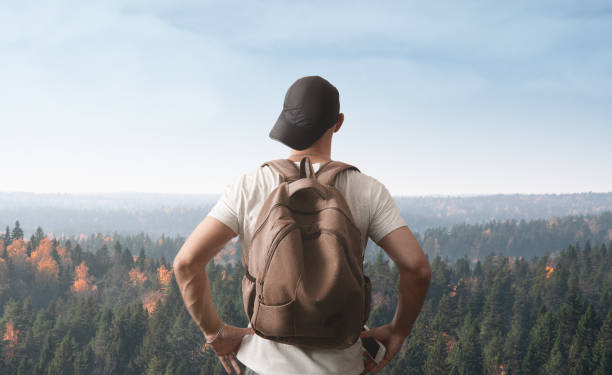 istock A man stands on a hill and looks at the forest. Far from civilization concept. 1285068467