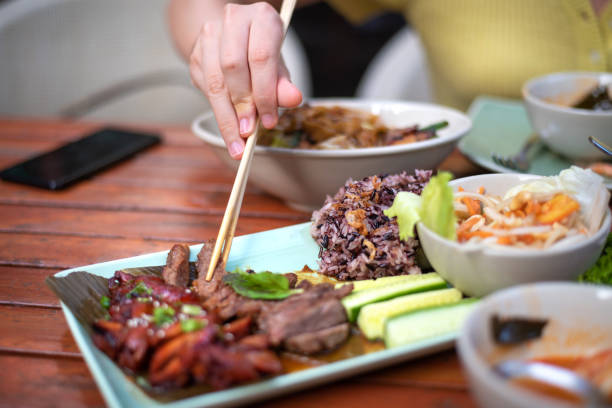 istock Woman having duck and beef Thai barbecue meal 1285068550