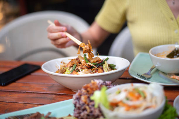 istock Woman having fried Thai noodles 1285068566