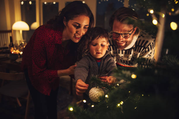 istock Family decorating Christmas tree together 1285068634