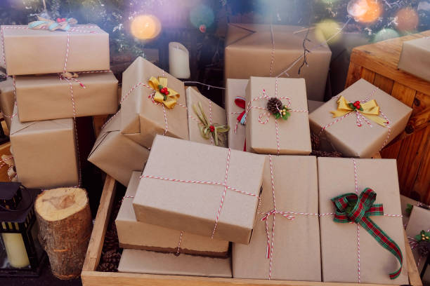 istock Gift box wrapped in recycled paper with ribbon bow 1285068984