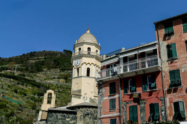 The facade with bell tower of church St. John the Baptist in Monterosso al Mare is made in the Genoese Gothic style. The architectural composition is decorated with a pointed arches