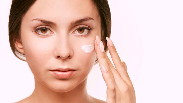 istock Young woman with white cream. Sun care lotion 1285074079