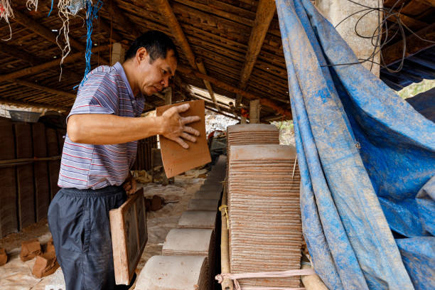 Tiles are handmade in Bac Son in Vietnam Bac Son, Long Son, Vietnam - November 22, 2019: Tiles are handmade in Bac Son in Vietnam adobe oven stock pictures, royalty-free photos & images